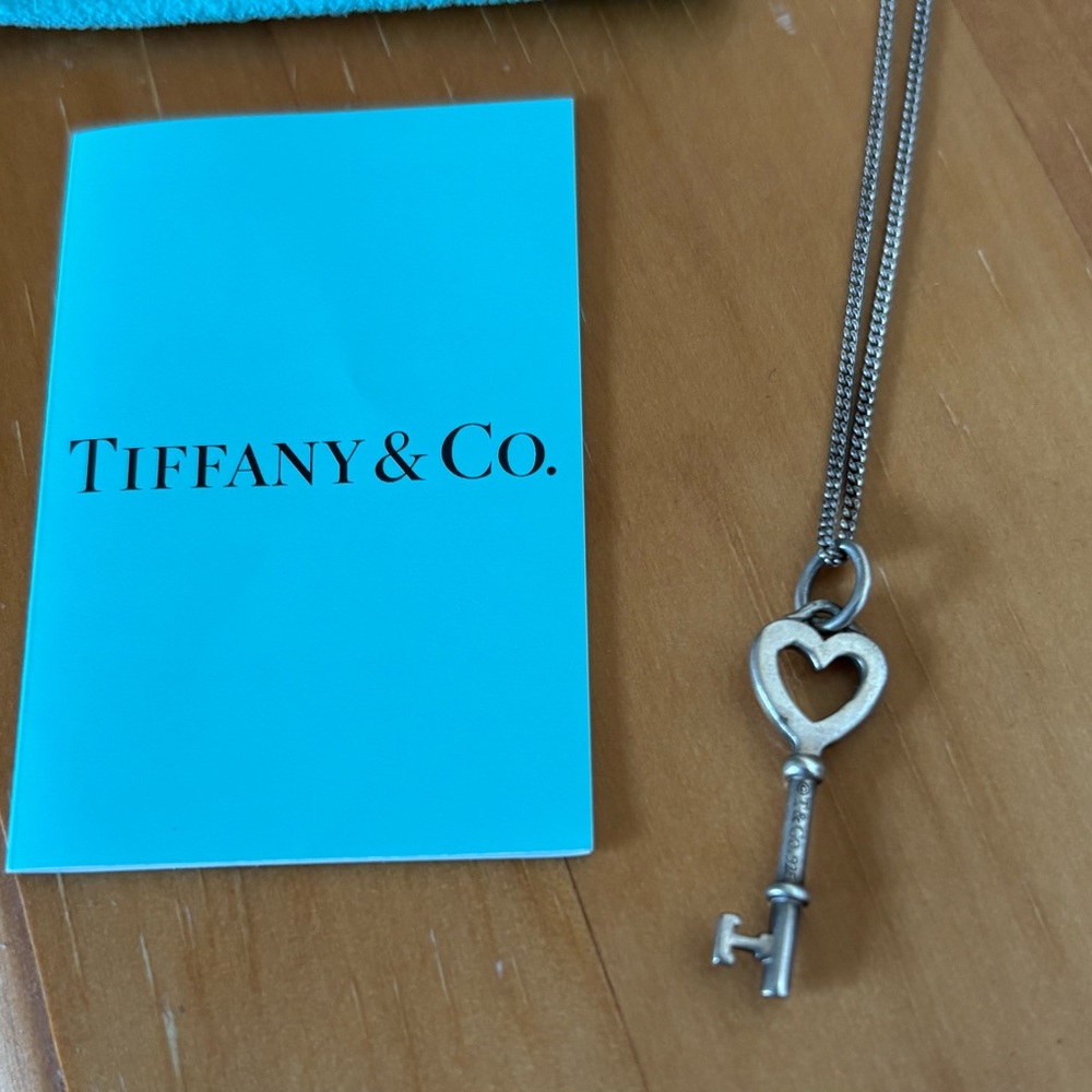 Tiffany & Co. Silver Heart Key necklace with bag, box, and verification card.